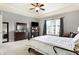 Spacious bedroom featuring a dresser, TV, ceiling fan, and large window for natural light at 16129 Brookhollow Dr, Westfield, IN 46062