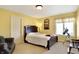 Comfortable bedroom with a reading nook, soft carpet and warm yellow walls at 16129 Brookhollow Dr, Westfield, IN 46062