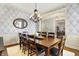 Formal dining room featuring a wood table and chairs, an elegant chandelier, and decorative wallpaper at 16129 Brookhollow Dr, Westfield, IN 46062
