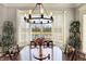 Charming dining room with a view of the pond through shuttered windows and stylish chandelier at 16129 Brookhollow Dr, Westfield, IN 46062