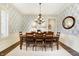 Stylish dining room featuring a modern chandelier, elegant wallpaper, and seating for eight for hosting dinner parties at 16129 Brookhollow Dr, Westfield, IN 46062