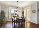 Sun-lit dining area with shuttered windows, chandelier, and wood floors at 16129 Brookhollow Dr, Westfield, IN 46062