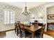 Elegant dining room with a stylish chandelier, hardwood floors, and a large window for natural lighting at 16129 Brookhollow Dr, Westfield, IN 46062