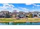 A beautifully landscaped backyard with a pond view and a screened in porch at 16129 Brookhollow Dr, Westfield, IN 46062