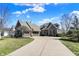 Beautiful home boasts a three-car garage, lush green lawn, and striking stone exterior at 16129 Brookhollow Dr, Westfield, IN 46062