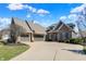 Impressive home with a stone facade, spacious driveway, and lush landscaping at 16129 Brookhollow Dr, Westfield, IN 46062