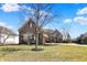 Charming home showcasing a stone exterior, mature trees, and a well-manicured lawn at 16129 Brookhollow Dr, Westfield, IN 46062