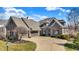 Stunning stone home featuring a three-car garage and meticulously maintained lawn at 16129 Brookhollow Dr, Westfield, IN 46062