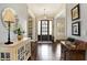 Grand foyer with hardwood floors, decorative millwork, and stylish accents creates a warm and welcoming ambiance at 16129 Brookhollow Dr, Westfield, IN 46062