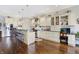 Open kitchen with light cabinets, stainless steel appliances, a large island, and hardwood floors at 16129 Brookhollow Dr, Westfield, IN 46062