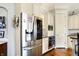 Bright kitchen boasts stainless steel appliances, including a large refrigerator and white cabinetry at 16129 Brookhollow Dr, Westfield, IN 46062