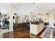 Open concept kitchen and living area boasts hardwood floors, a fireplace, and an island with bar seating at 16129 Brookhollow Dr, Westfield, IN 46062