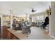 Spacious living room featuring hardwood floors, neutral carpeting, comfortable seating, and a grand piano at 16129 Brookhollow Dr, Westfield, IN 46062