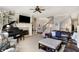 Open-concept living room with a fireplace, built-in shelves, a piano, and a staircase at 16129 Brookhollow Dr, Westfield, IN 46062