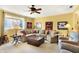 Comfortable living room features large sectional couch, natural light, and ceiling fan at 16129 Brookhollow Dr, Westfield, IN 46062