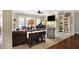 Bright living room boasts a fireplace, built-in bookshelves, a grand piano, and large windows at 16129 Brookhollow Dr, Westfield, IN 46062