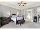 Elegant main bedroom boasts a four-poster bed, sitting area, and ensuite access at 16129 Brookhollow Dr, Westfield, IN 46062