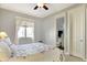Relaxing bedroom with a decorative ceiling fan, bright natural light, and a private bathroom at 16129 Brookhollow Dr, Westfield, IN 46062