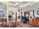 Cozy office with coffered ceiling, desk, and a view of the dining room through French doors at 16129 Brookhollow Dr, Westfield, IN 46062