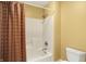 Shower with white surround, shower head, and bronze colored shower curtain at 16129 Brookhollow Dr, Westfield, IN 46062