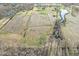 Expansive aerial view shows a multi-acre lot with a pond, mature trees, and multiple building structures at 1636 N County Road 425 E, Avon, IN 46123