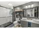 Bathroom featuring double sinks, a modern glass enclosed tile shower, modern vanity, and stylish fixtures at 1636 N County Road 425 E, Avon, IN 46123