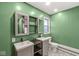 Bathroom featuring light green walls, a modern vanity, and decorative floor tiles at 1636 N County Road 425 E, Avon, IN 46123