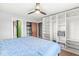 Bedroom with light walls, a ceiling fan, wood floors, and closet space with lots of shelving at 1636 N County Road 425 E, Avon, IN 46123
