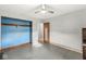 Bedroom with light grey walls, painted wood floors, a ceiling fan, and a closet with a blue interior at 1636 N County Road 425 E, Avon, IN 46123