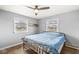 Bright bedroom with wood floors, a ceiling fan, and natural light from two windows with open views at 1636 N County Road 425 E, Avon, IN 46123