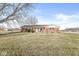 Charming single-story brick home with a well-maintained front lawn and beautiful landscaping under a clear blue sky at 1636 N County Road 425 E, Avon, IN 46123