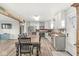 Open-concept kitchen with white cabinets, stainless appliances, dining table, and wood flooring at 1636 N County Road 425 E, Avon, IN 46123