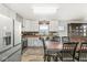 Modern kitchen with stainless steel appliances, custom backsplash, and an adjacent wooden dining table at 1636 N County Road 425 E, Avon, IN 46123