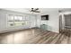 A well-lit living room with wood flooring, a large window, and a view of the front yard, creating a warm, inviting space at 1636 N County Road 425 E, Avon, IN 46123