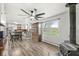Spacious living room with a modern ceiling fan, wood floors, vintage hutch, and a large window with a view at 1636 N County Road 425 E, Avon, IN 46123