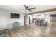 A cozy living room featuring wood flooring, a ceiling fan, and an open-concept design leading to a kitchen area at 1636 N County Road 425 E, Avon, IN 46123