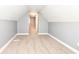 Finished attic space with gray walls and white trim, leading to other rooms at 1653 S Delaware St, Indianapolis, IN 46225