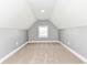 Carpeted attic space with gray walls, white trim, and natural light from a window at 1653 S Delaware St, Indianapolis, IN 46225