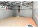 Unfinished basement with concrete floor, painted walls and exposed pipes at 1653 S Delaware St, Indianapolis, IN 46225