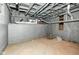 Unfinished basement with concrete floor, painted walls, and exposed pipes at 1653 S Delaware St, Indianapolis, IN 46225