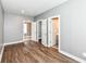Bedroom with wood floors, light gray walls and a view to closet and bathroom at 1653 S Delaware St, Indianapolis, IN 46225