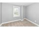 Bright bedroom features a window and soft carpeting, creating a cozy and inviting atmosphere at 1653 S Delaware St, Indianapolis, IN 46225