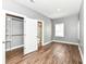 Bedroom with wood floors, light gray walls and a view to closet and bathroom at 1653 S Delaware St, Indianapolis, IN 46225