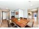 Dining room featuring a rustic wood table and contemporary decor with seamless transition to kitchen and laundry areas at 1653 S Delaware St, Indianapolis, IN 46225