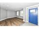 Entryway featuring wood floors, light gray walls, blue front door and a view to living area at 1653 S Delaware St, Indianapolis, IN 46225