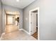 Hallway with tile floors, light gray walls, views to kitchen and doorway at 1653 S Delaware St, Indianapolis, IN 46225