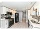 Modern kitchen features stainless steel appliances, white cabinets, and stylish tile backsplash at 1653 S Delaware St, Indianapolis, IN 46225