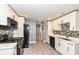 Modern kitchen features stainless steel appliances, white cabinets, and stylish tile backsplash at 1653 S Delaware St, Indianapolis, IN 46225