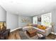 Staged living room with couch, rug, coffee table, and neutral decor at 1653 S Delaware St, Indianapolis, IN 46225