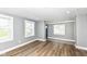 Living room with wood floors, light gray walls, double-hung windows and a view to the entryway at 1653 S Delaware St, Indianapolis, IN 46225